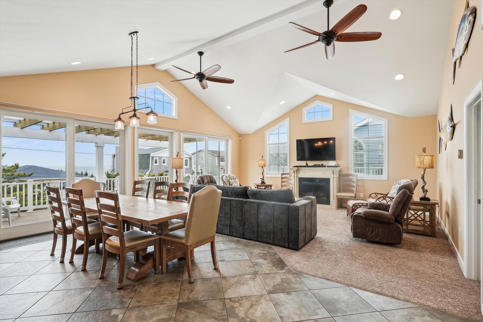 Unwind in your spacious living area with soaring ceilings, cozy fireplace, and abundant natural light streaming through walls of windows that frame stunning mountain views.