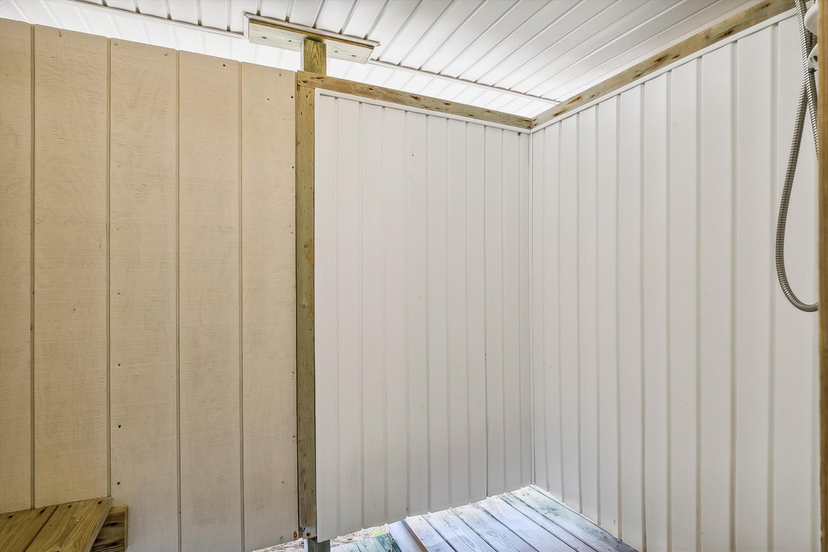 A bright, clean utility space with fresh white paneling and practical wood trim—offering secure storage for your gear and belongings during your stay.