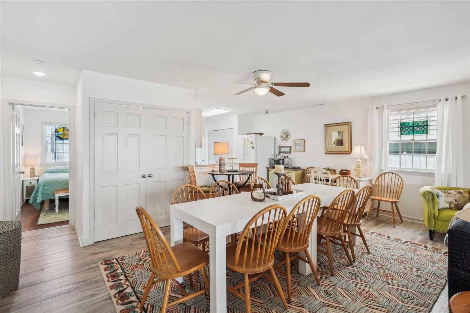 Gather around the spacious dining table where warm wood tones and coastal charm create the perfect setting for your shared meals and late-night conversations.