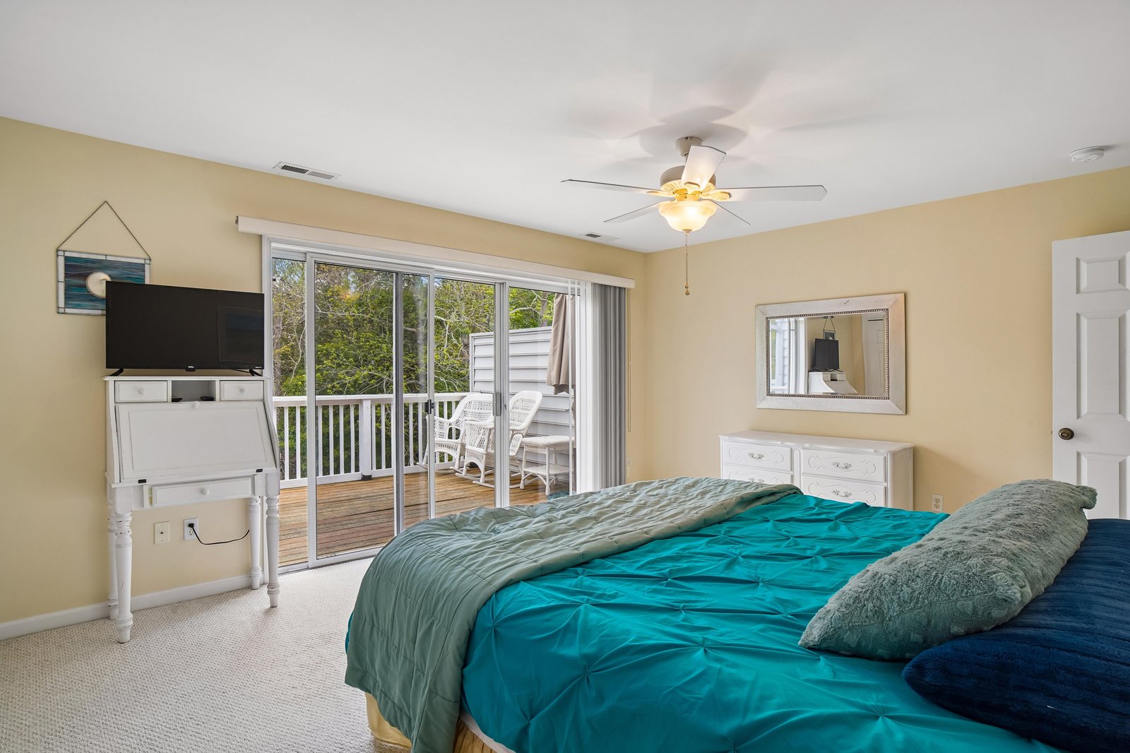Step into your sunlit bedroom where coastal breezes flow through balcony doors, plush bedding invites restful sleep, and morning coffee on your private deck begins each day perfectly.