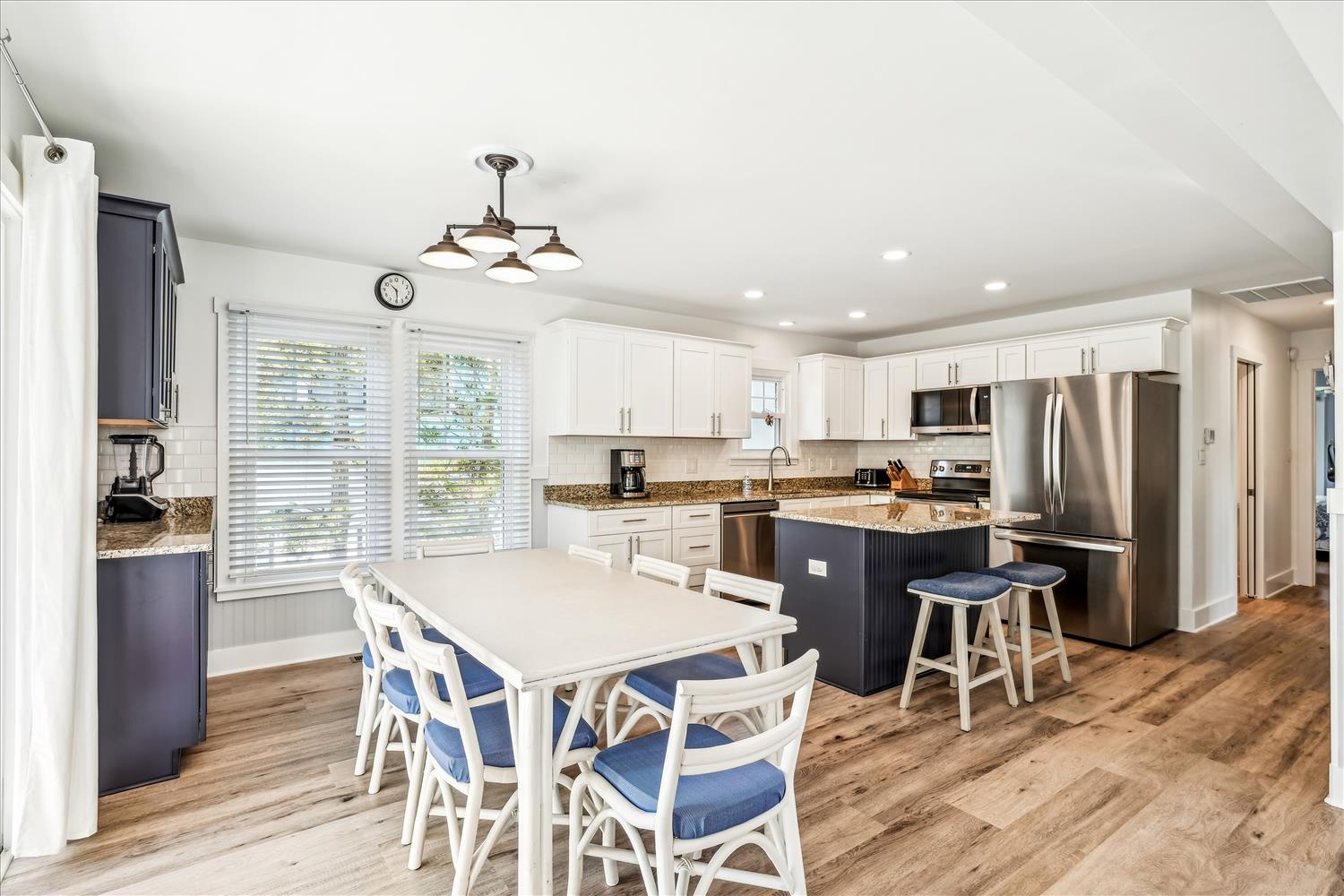 Step into your open kitchen and dining space, where granite countertops, stainless appliances, and warm wood floors invite you to gather and create memorable meals together.