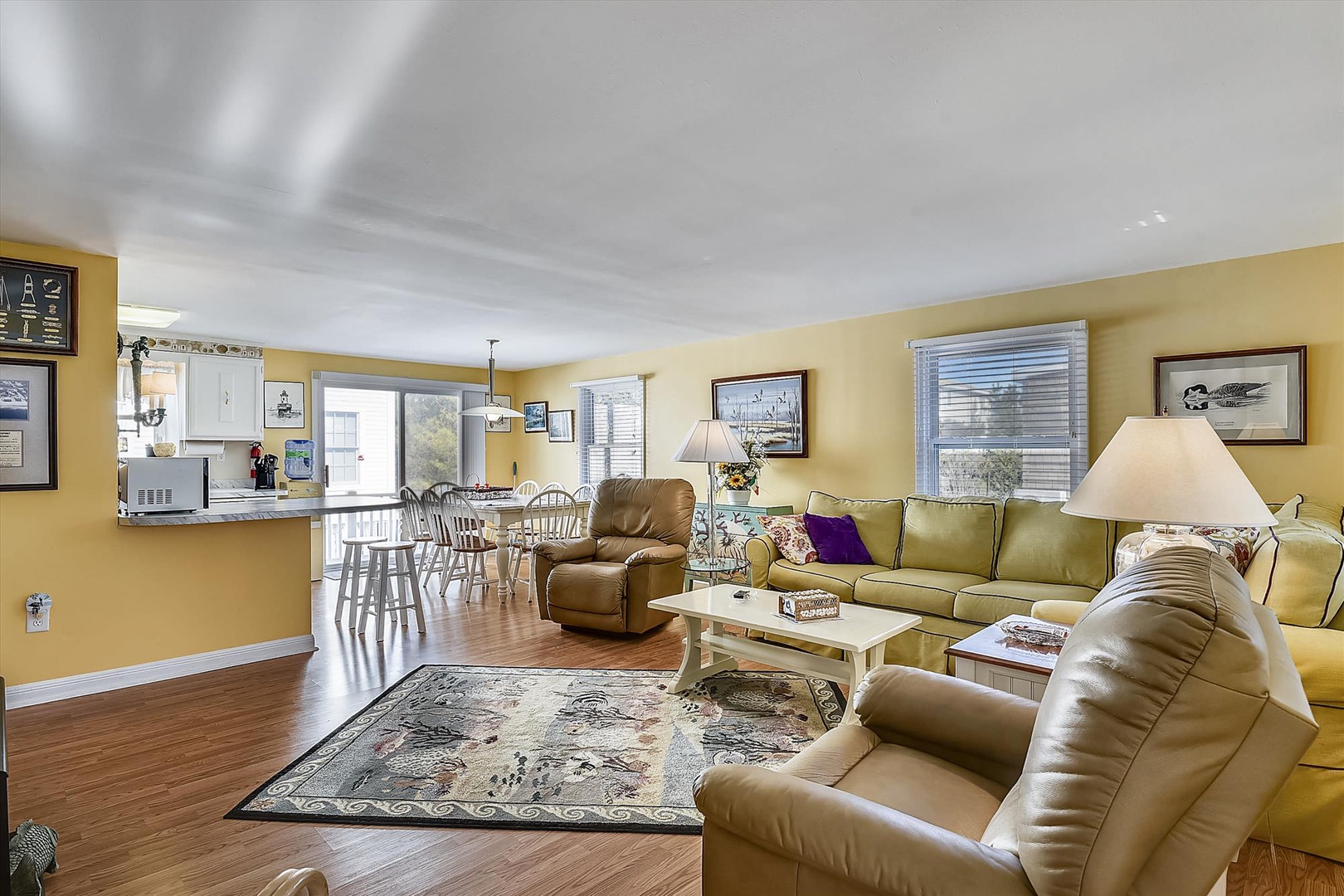 Your bright, open living space flows seamlessly into the dining area and kitchen, perfect for gathering with loved ones and enjoying comfortable coastal relaxation.
