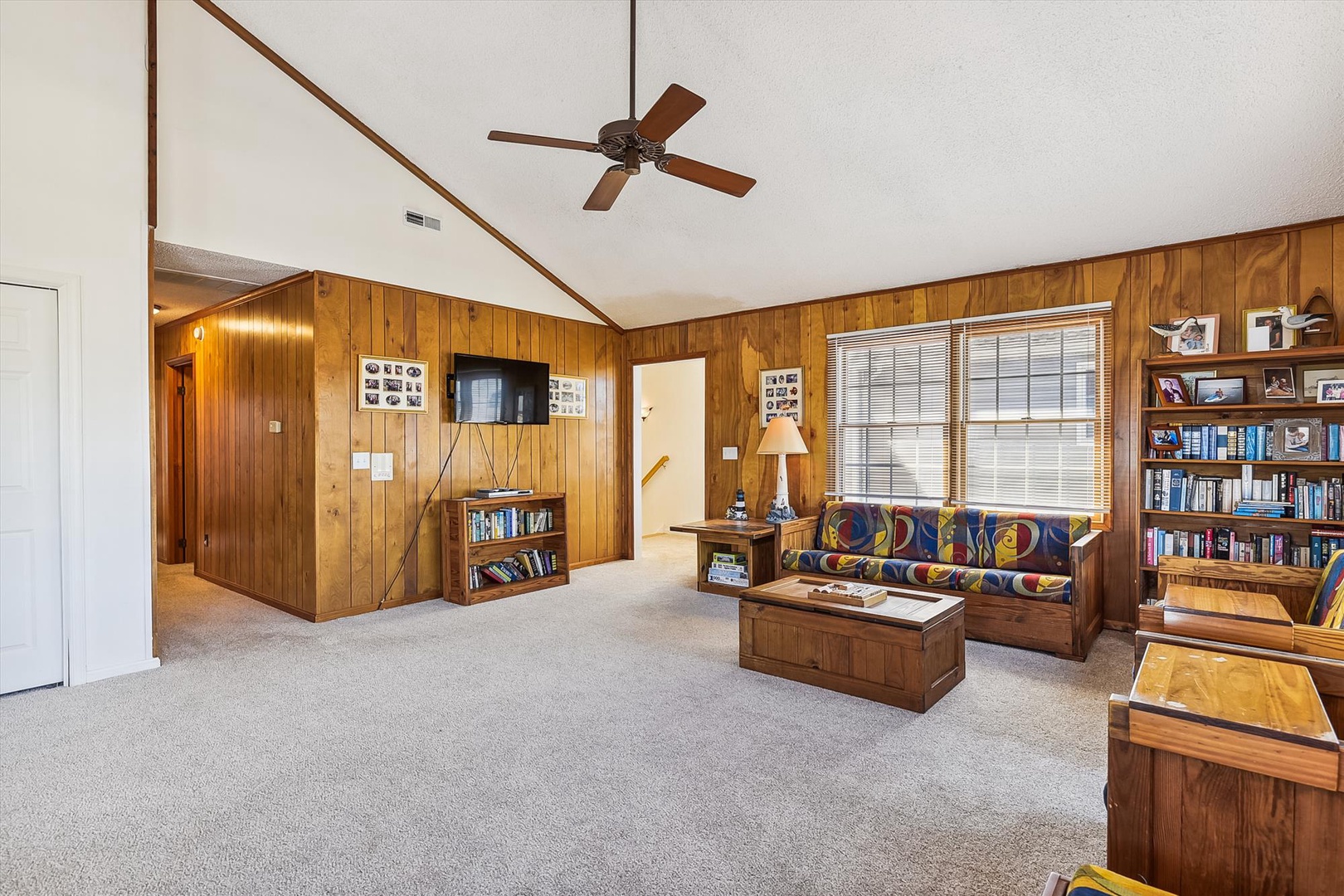 Settle into your own cozy library retreat with rich wood paneling, a cheerful reading lamp by the window, and shelves lined with books—perfect for quiet afternoons with your favorite stories.