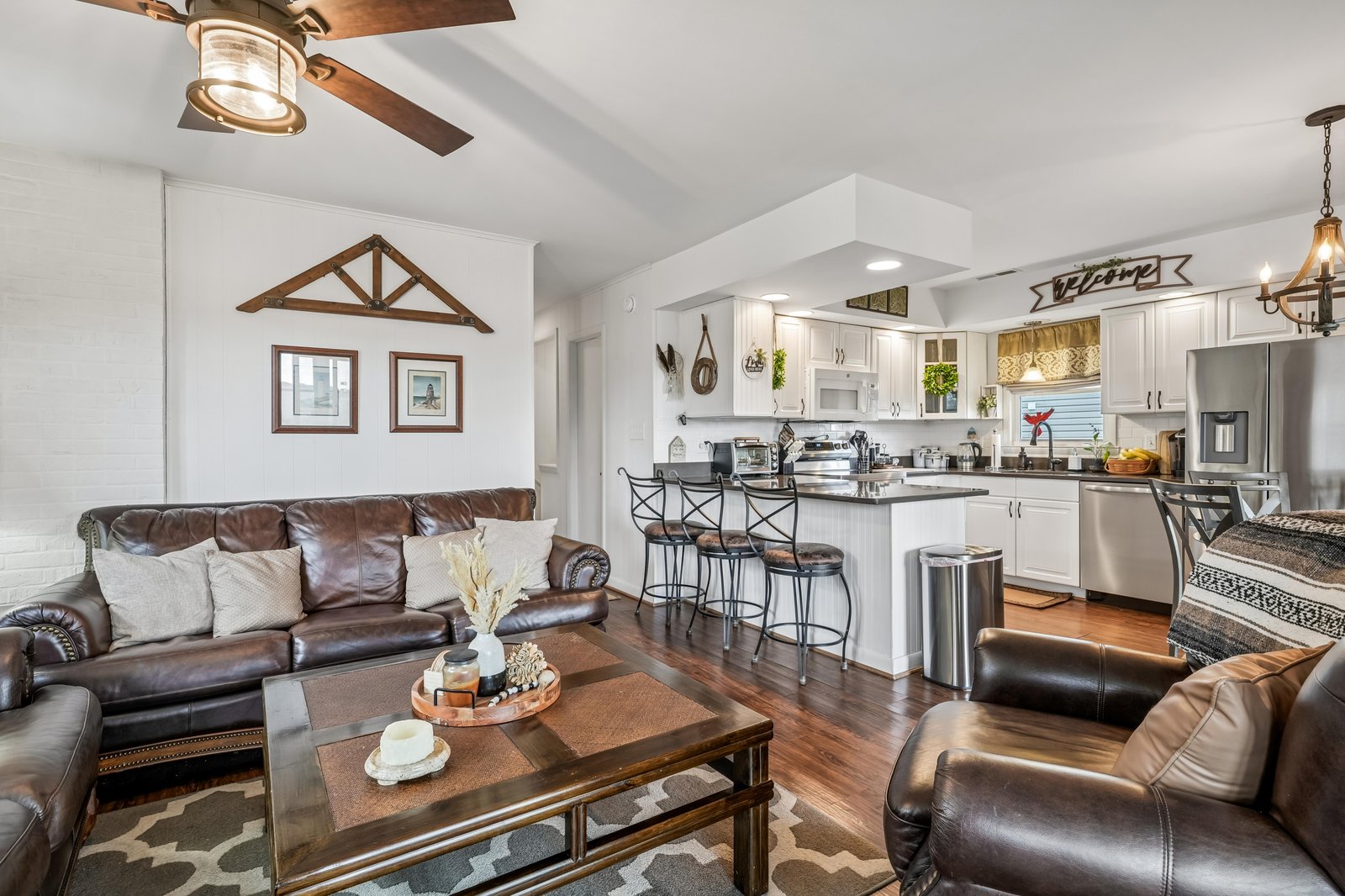 Settle into plush leather seating in your open-concept living space, where rustic charm meets modern comfort. The full kitchen awaits your culinary adventures, complete with stainless appliances and a welcoming island for gathering over meals and memories