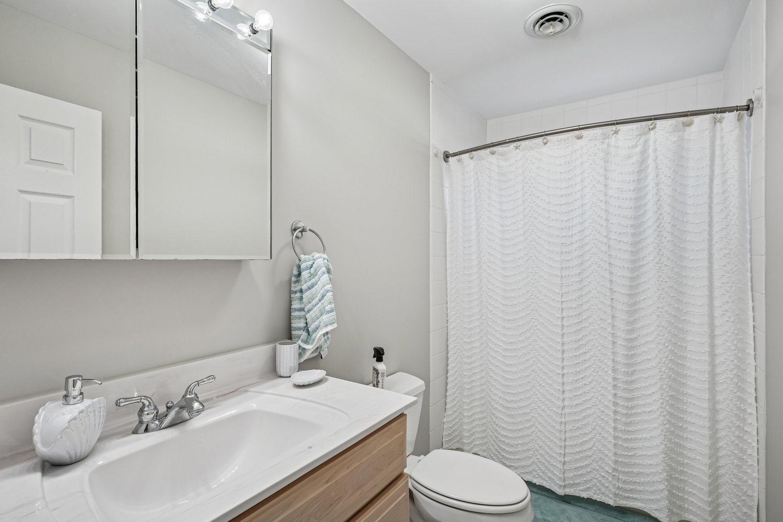 Your private bathroom features a clean, modern design with a vanity and fresh towels, plus a spacious shower area for a refreshing start to your day.