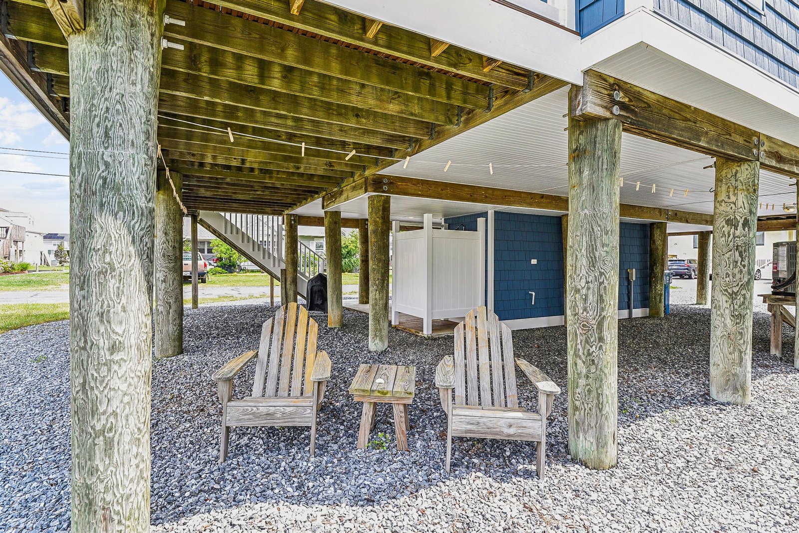 This elevated property features a shaded outdoor seating area beneath, perfect for relaxing after a day of exploring the local area.