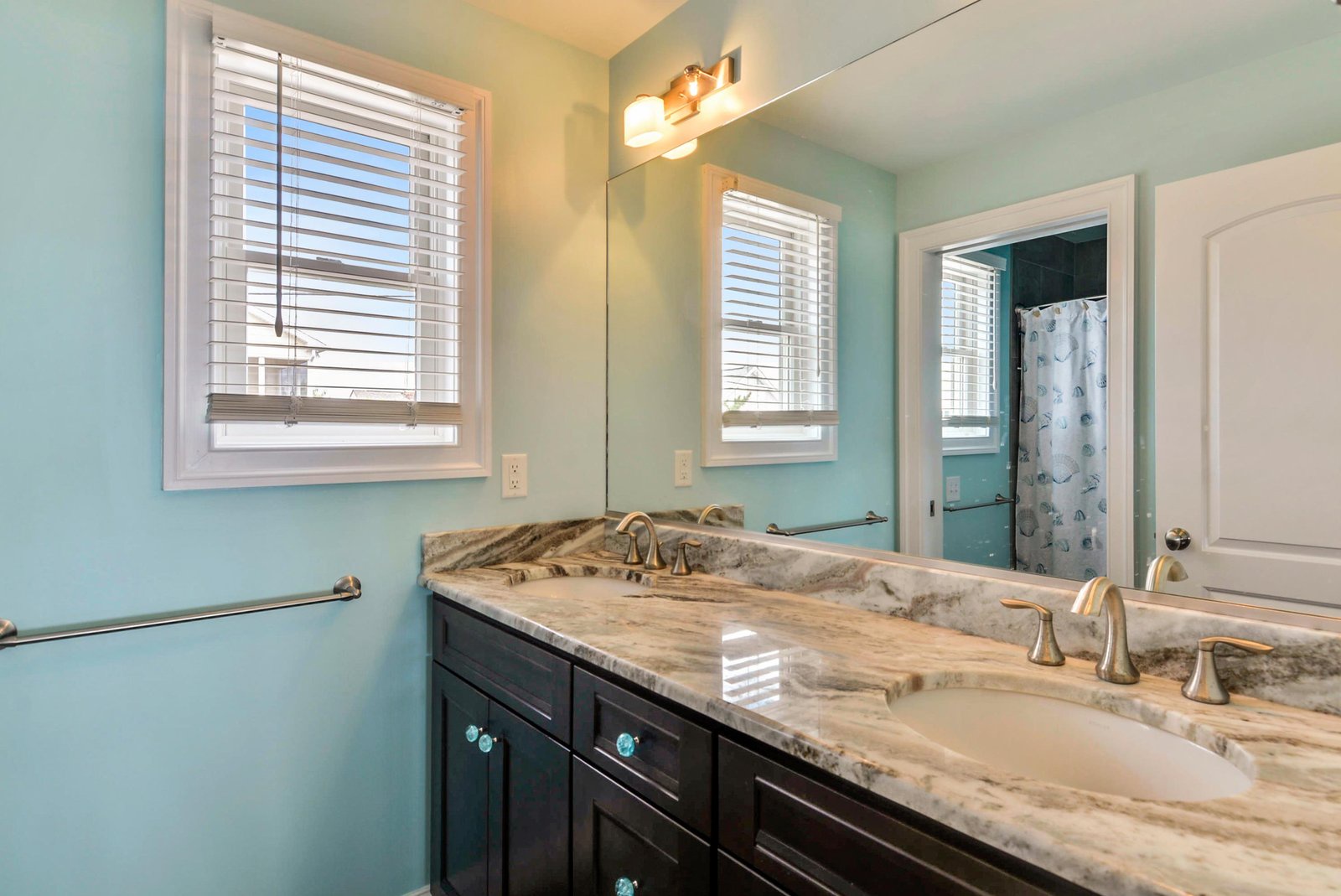 Step into your private bathroom, where natural light pours in and beautiful marble countertops frame dual sinks—perfect for getting ready together in the morning.