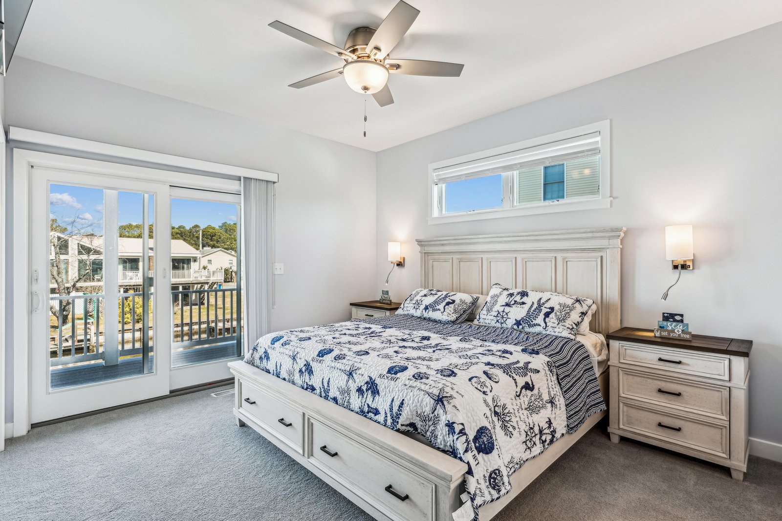 Wake up refreshed in this bright, coastal-inspired bedroom. The sliding glass doors invite in natural light and fresh air, while your plush bed promises restful nights after days of adventure.