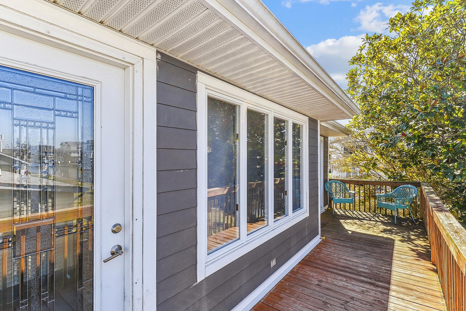 Step onto your private covered deck and breathe in the fresh air. With plenty of space for outdoor seating and beautiful greenery just beyond, it's the perfect spot to sip morning coffee or unwind in the afternoon sun.