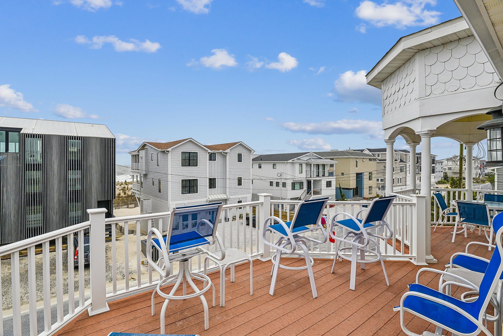 Sip your morning coffee at this breezy rooftop deck with coastal architecture all around, just steps from the shore.