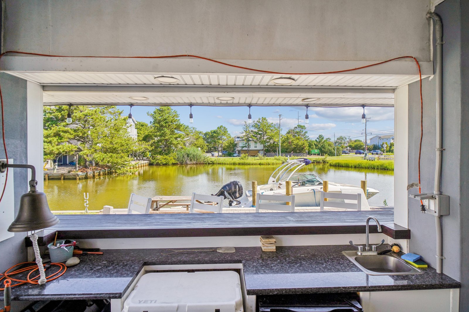 The property sits along a peaceful waterway with a private boat dock and direct access to the water, perfect for boating and fishing enthusiasts.