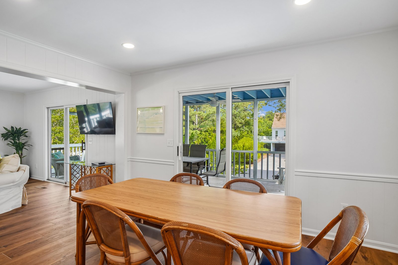 Step into your bright, inviting dining area where meals feel special. Large glass doors frame lush garden views and open to your private balcony, blending indoor comfort with outdoor charm.