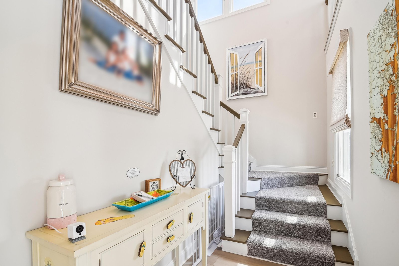 Sunlight streams through skylights onto your stairway, where soft carpet and coastal art create a welcoming entry to the upstairs bedrooms.