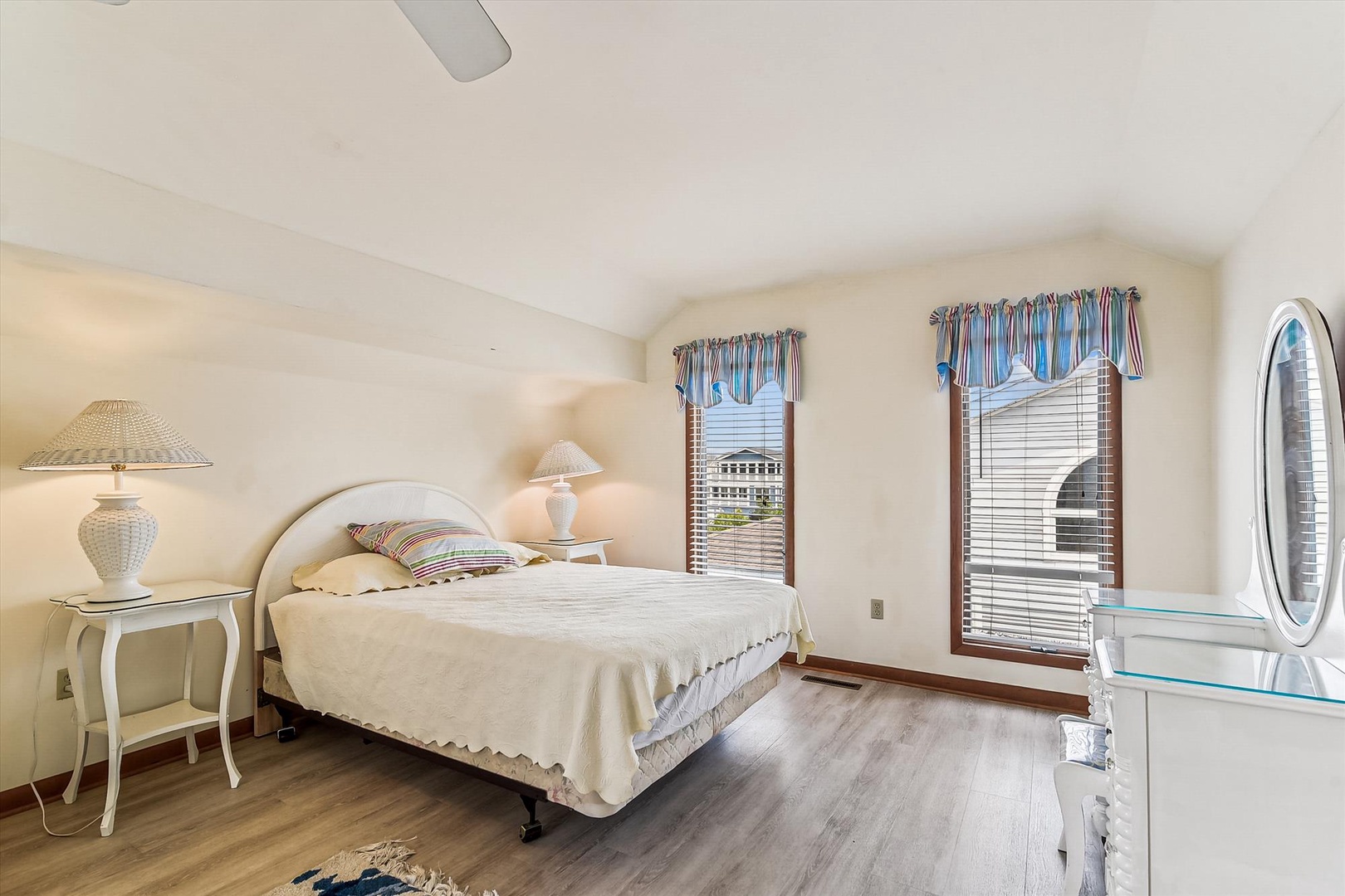 Your peaceful bedroom retreat features a comfortable bed, warm natural light through elegant windows, and plenty of space to unwind after exploring the area.