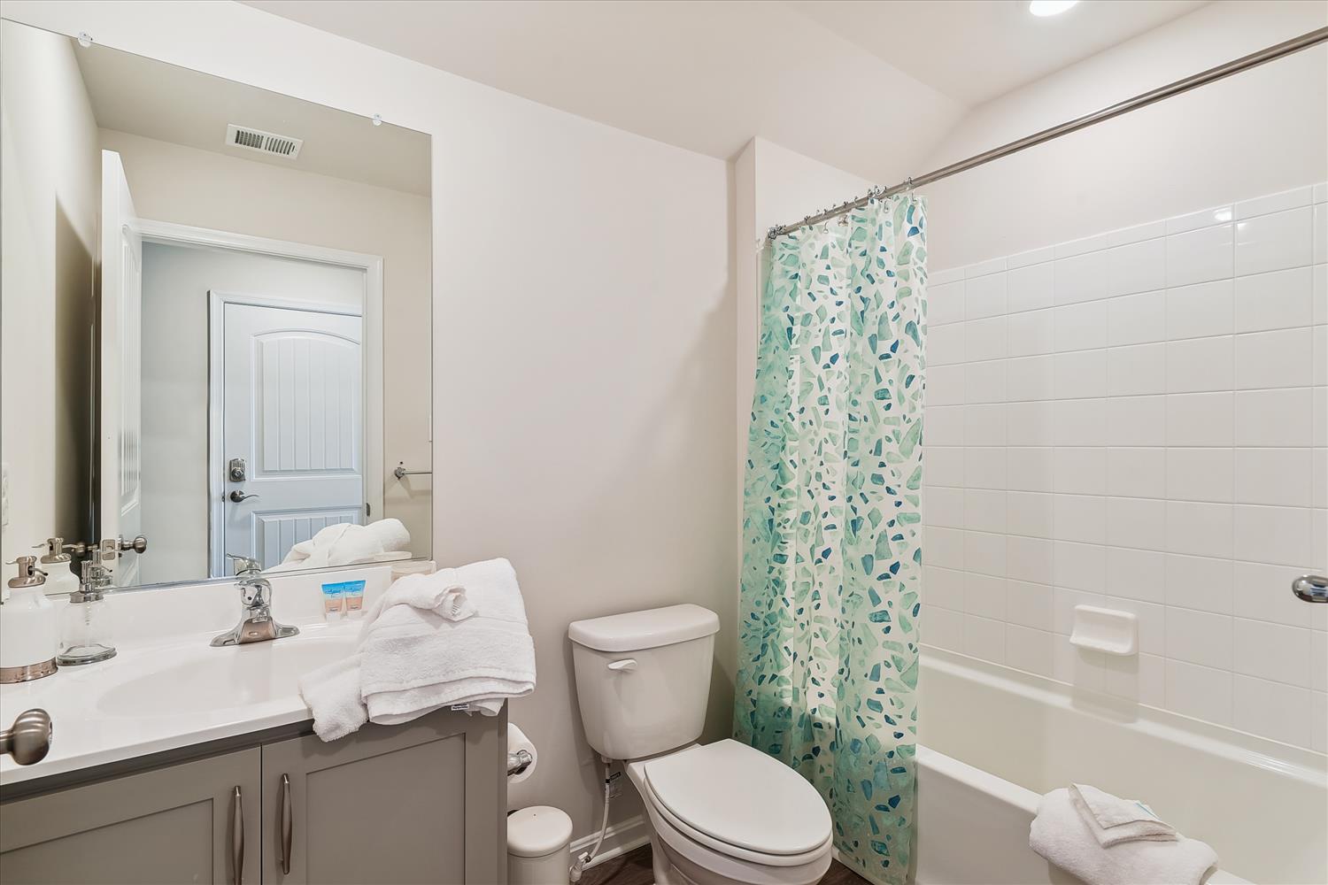 Your private bathroom features fresh linens, a relaxing tub-shower combo, and cheerful coastal-inspired touches for your comfort.