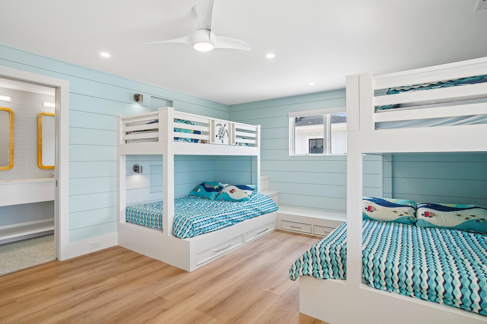Your kids will love this bright coastal bedroom with custom bunk beds and cheerful turquoise accents. Perfect for families, with room to spread out and make vacation memories together.