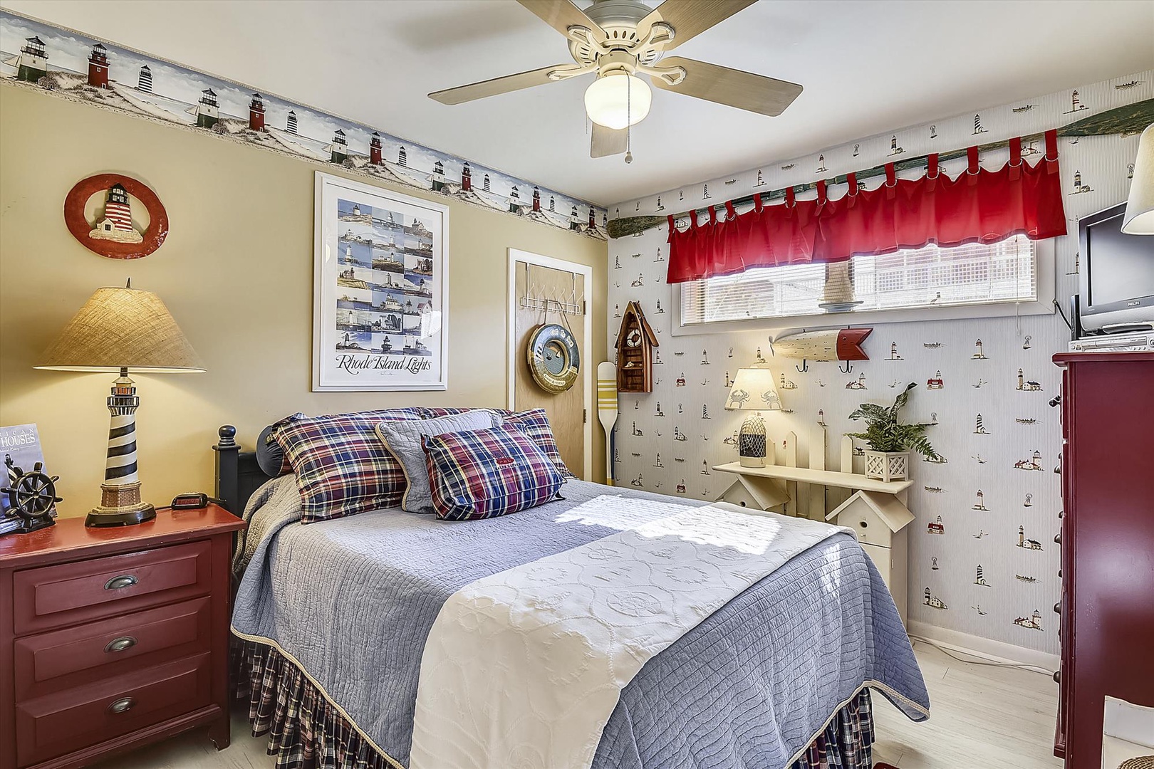 Relax in your cozy nautical-themed bedroom featuring a plush queen bed, charming lighthouse decor, and coastal accents that bring seaside tranquility to your stay.