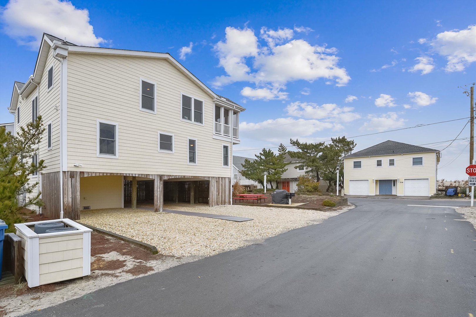 A coastal retreat featuring elevated architecture and generous parking space, located in a peaceful beachside neighborhood with easy access to the shore.