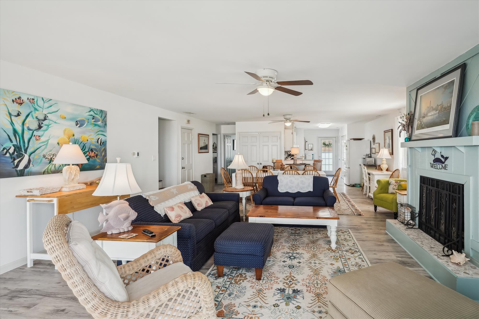 Relax in your bright, open living space with coastal charm, cozy seating, a fireplace, and plenty of room to gather with loved ones after a beach day.