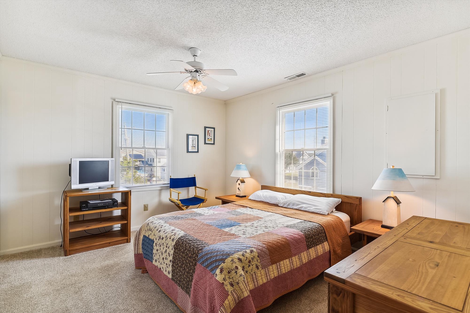 Unwind in your bright, airy bedroom where restful sleep awaits. Soft natural light streams through double windows, and a cozy quilt invites you to settle in after a day of exploring.