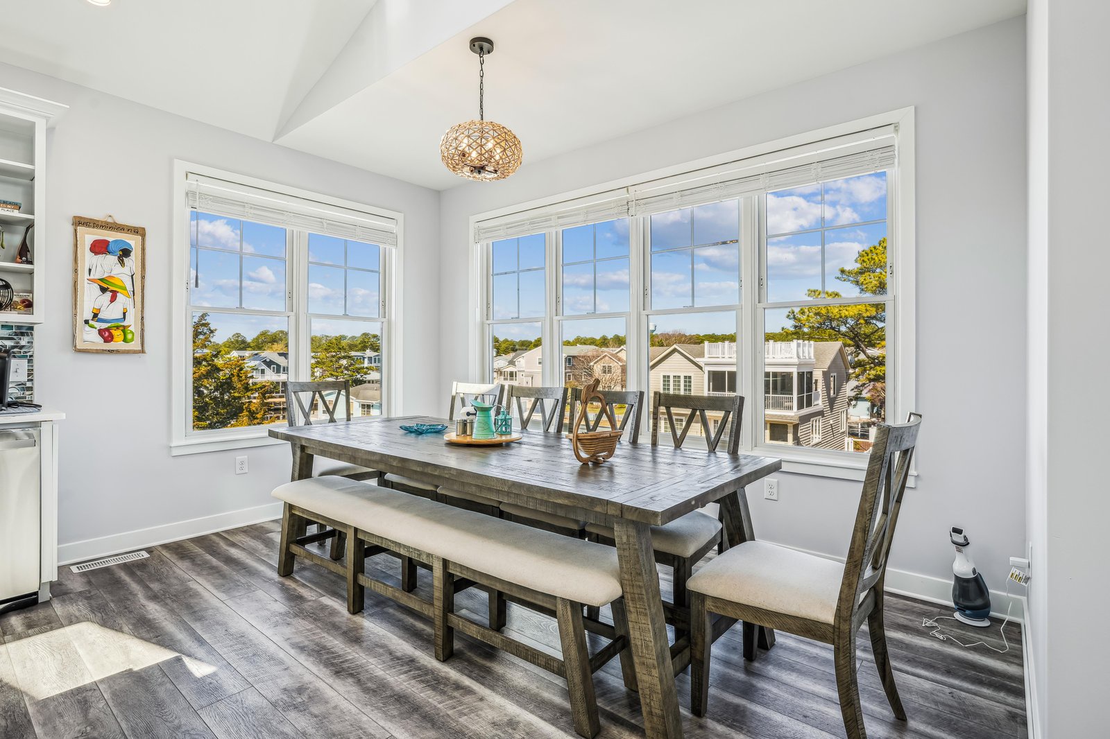 Gather around this spacious dining table with seating for eight, where sunlight and neighborhood views pour through floor-to-ceiling windows. Your group meals and game nights have found their perfect spot.