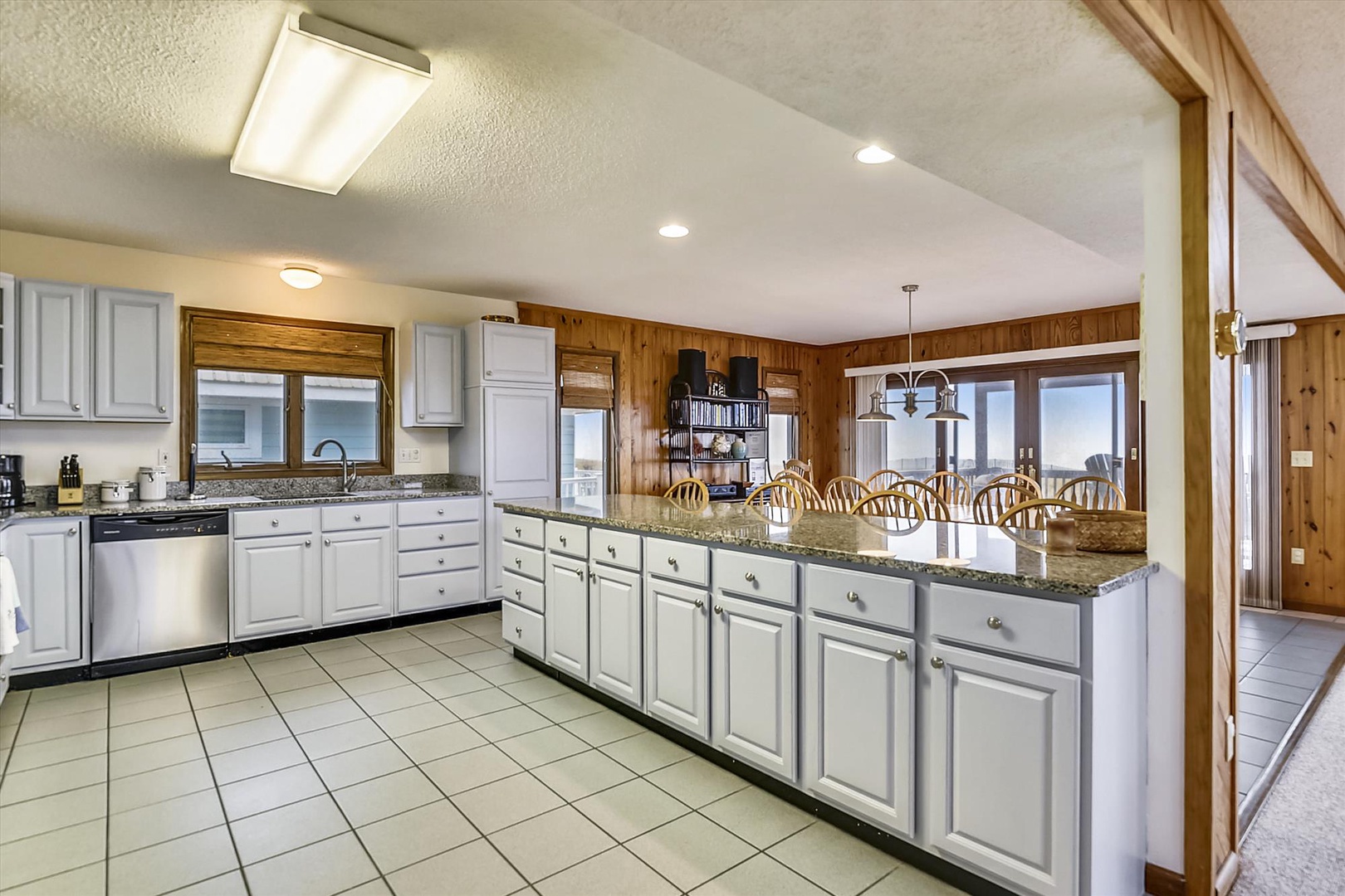 Spacious kitchen with granite counters, modern appliances, and breakfast bar seating where you'll love preparing meals and gathering with family.