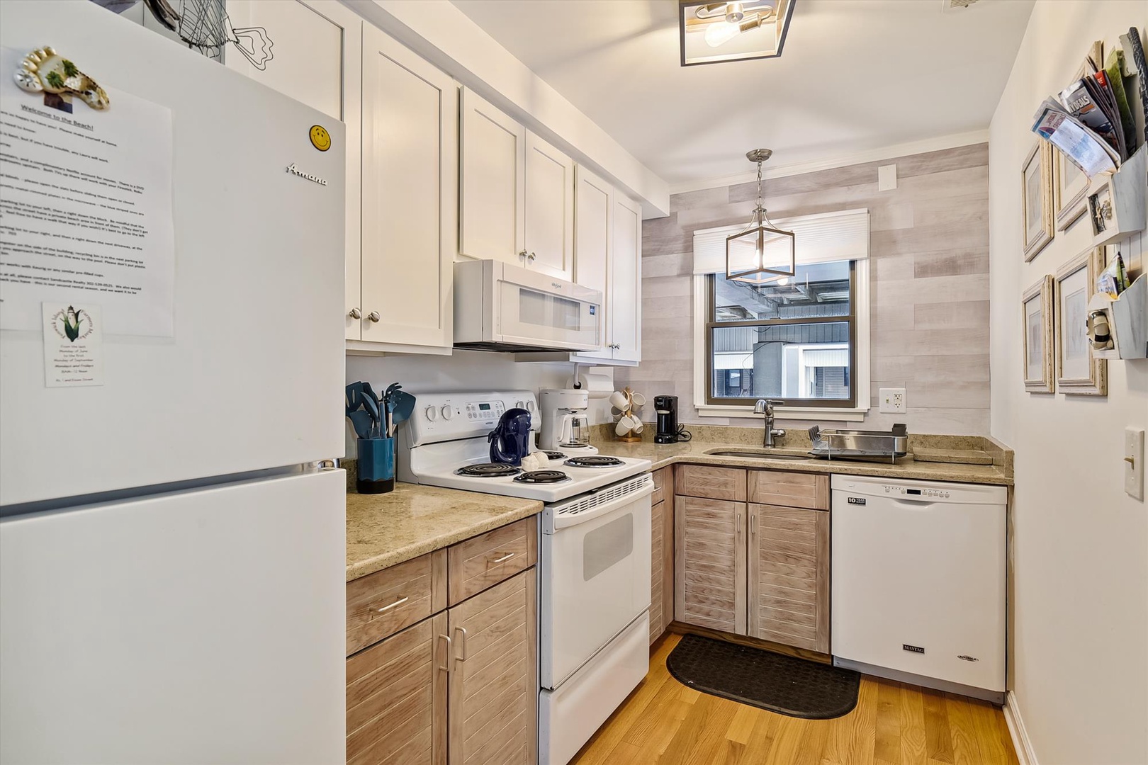 Your fully equipped kitchen features modern appliances, ample counter space, and everything you need to prepare meals during your stay. Warm wood tones and natural light create a welcoming space.
