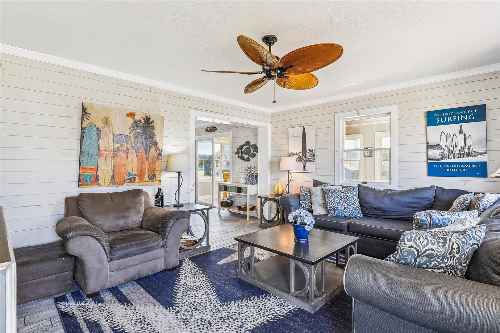 Unwind in your cozy coastal retreat with comfy seating, beach-inspired décor, and a tropical ceiling fan that sets a relaxed, vacation vibe.