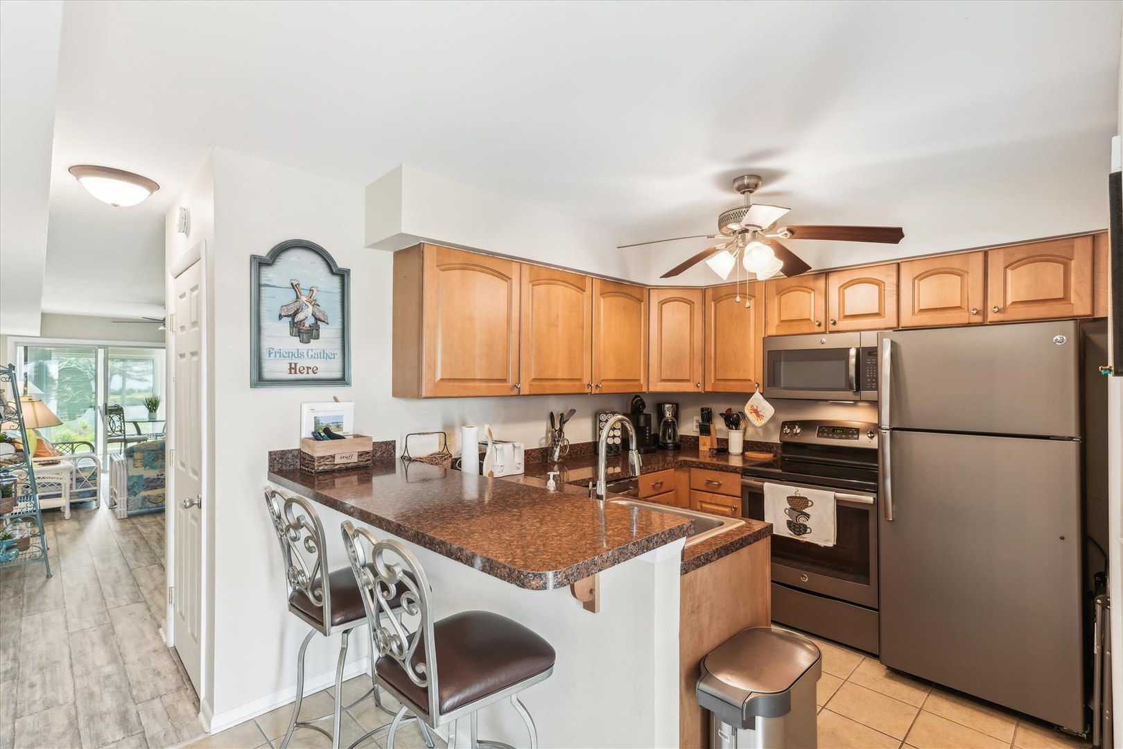 Your fully-equipped kitchen features granite countertops, stainless steel appliances, and a breakfast bar perfect for morning coffee or casual dining.