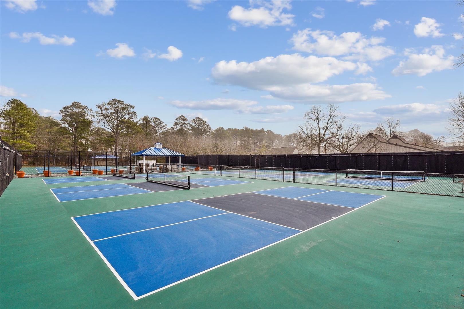 Multiple tennis courts with covered seating offer the perfect setting for your match. Surrounded by trees and open sky, this facility invites you to enjoy an active outdoor escape.