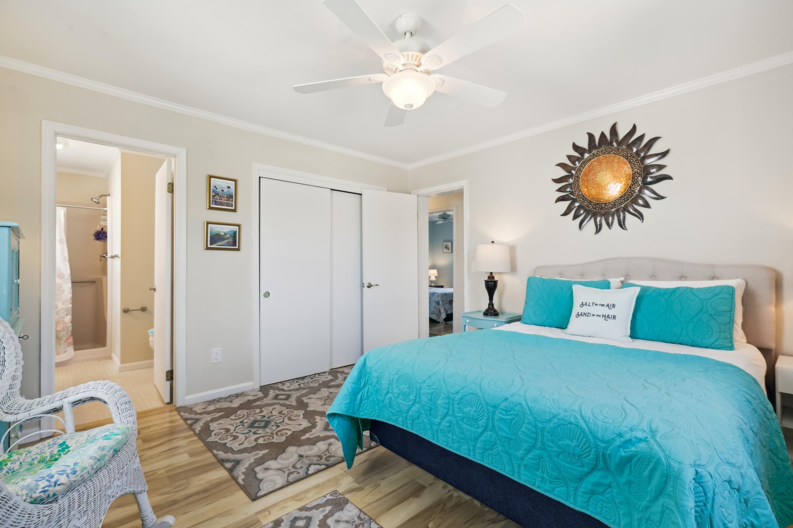 Slip into your plush bed with vibrant turquoise linens and drift off under the gentle breeze of the ceiling fan—your perfect escape awaits.