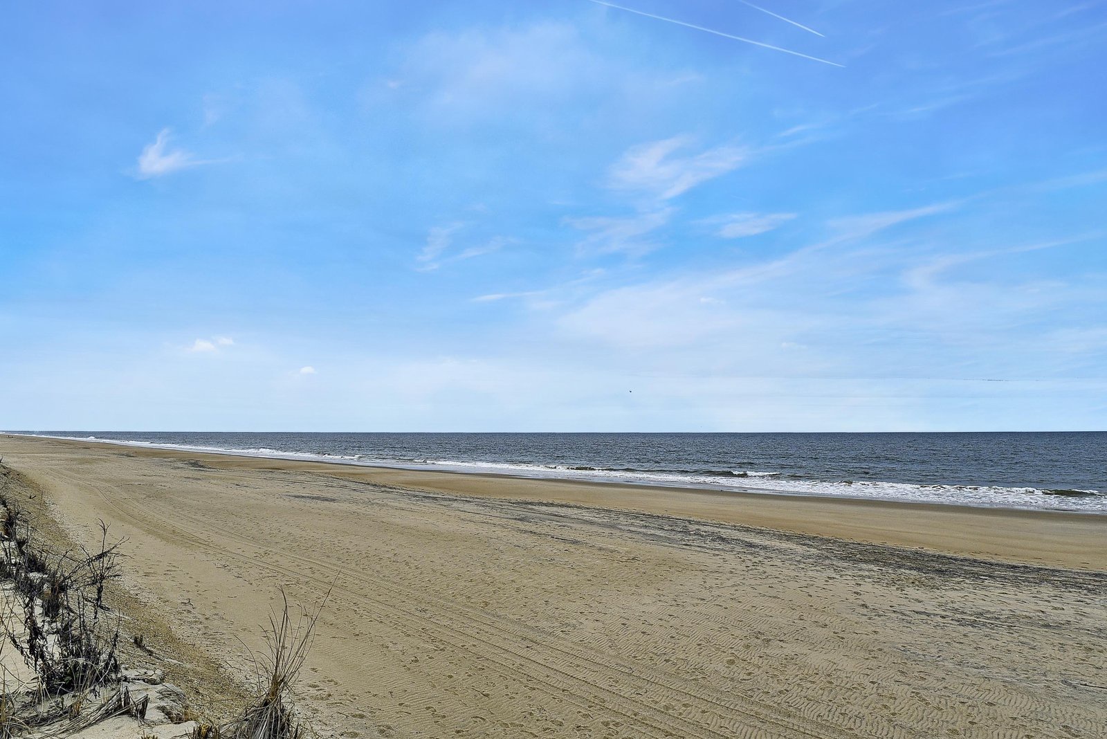 Wide sandy beach stretching along the oceanfront, part of the property's coastal location.