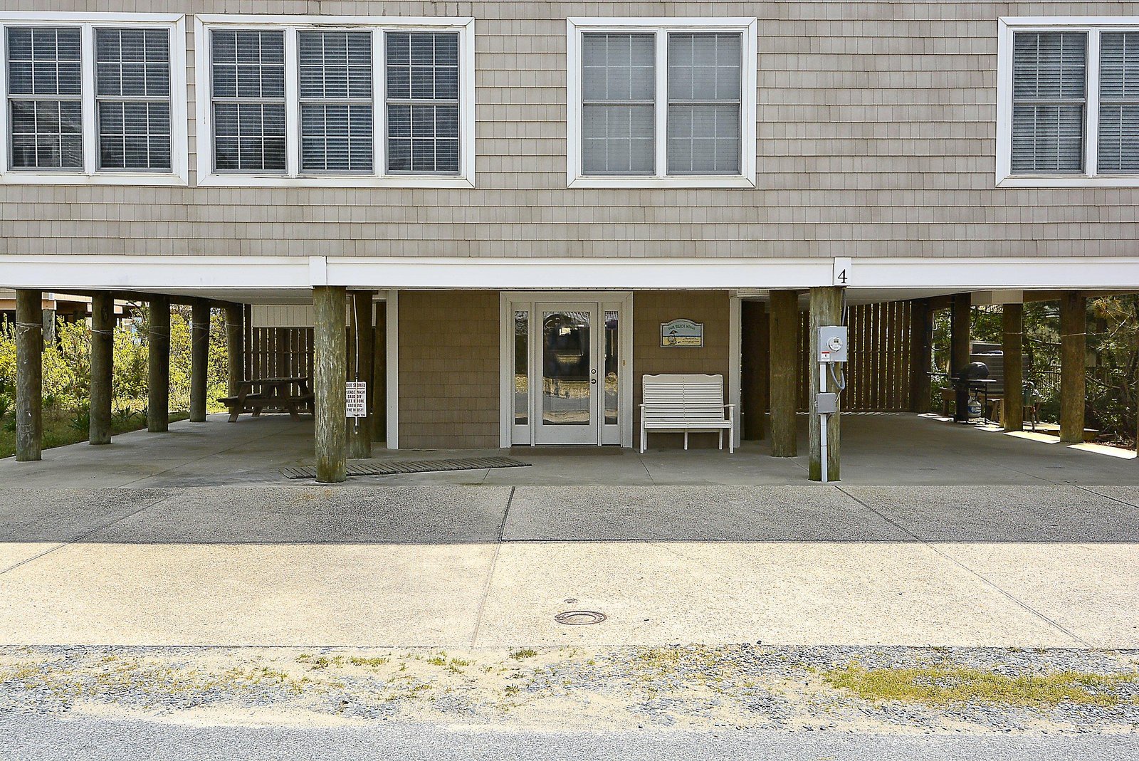 The property features covered ground-level parking with a prominent entrance located at unit 4, offering easy access upon arrival.