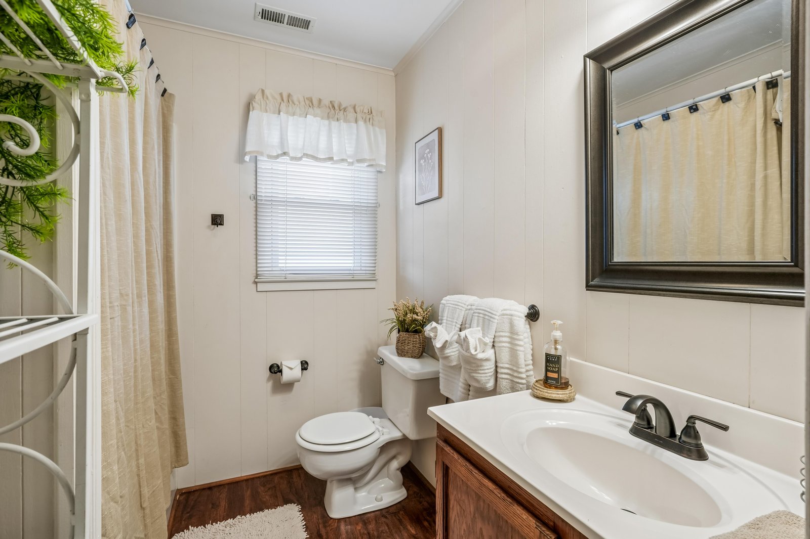 Step into your private bathroom with soft towels, natural light, and a warm, welcoming vibe that makes freshening up a pleasure.