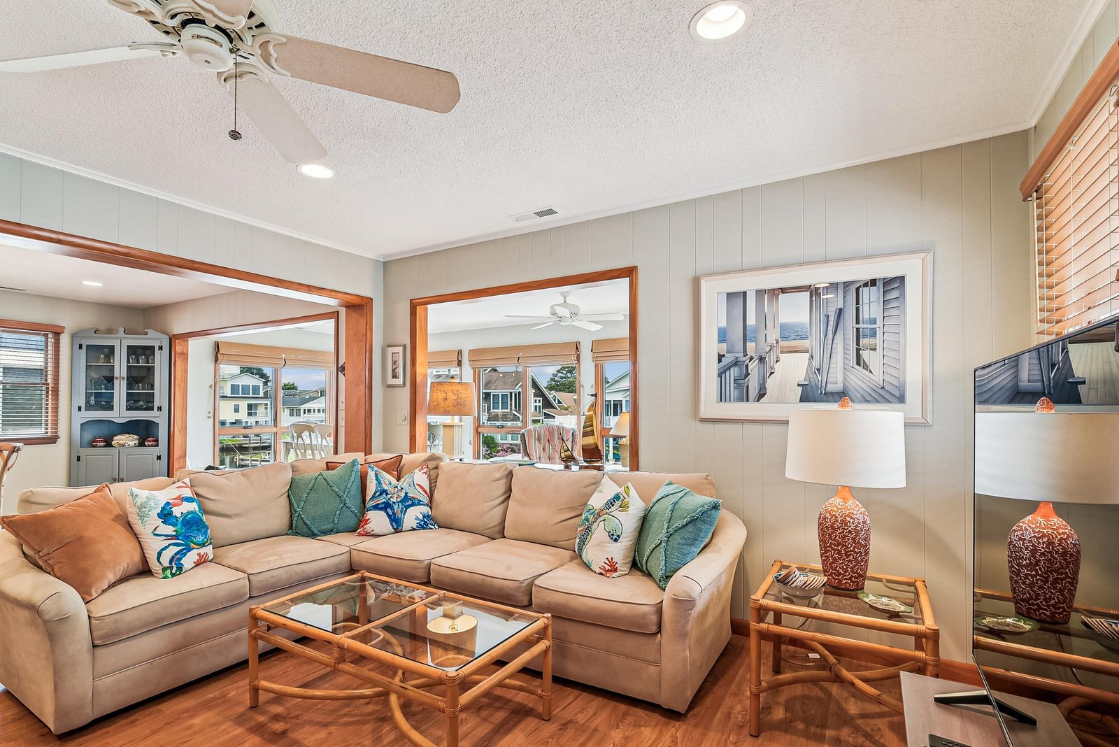 Relax in your coastal-chic living room with beachy accents, comfortable seating, and natural light streaming through the windows. Perfect for unwinding after a day of adventure.