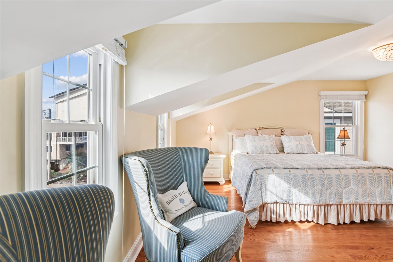 Wake up to soft morning light streaming through your windows in this charming bedroom. Sink into the plush king bed or curl up in the cozy wingback chair with your favorite book and coffee.