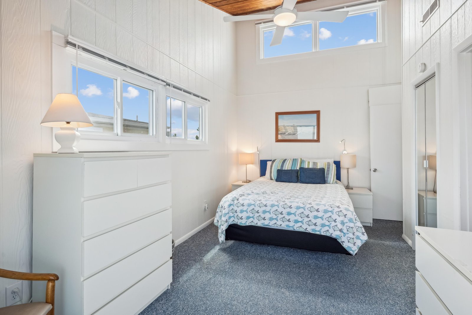 Step into your serene coastal retreat with soaring ceilings, white-washed walls, and natural light streaming through high windows. Crisp linens and gentle ocean-inspired accents make this your perfect sanctuary.