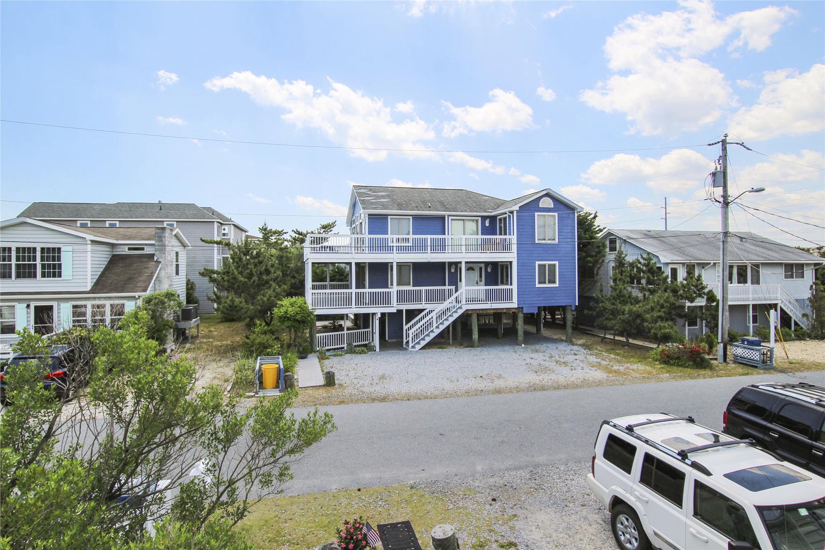 A spacious beachside property sits nestled in a coastal neighborhood with convenient parking and nearby homes, offering easy access to oceanfront living.