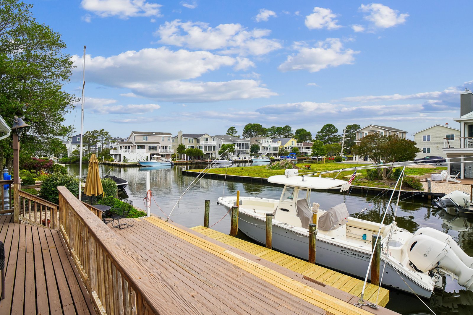 A peaceful waterfront neighborhood surrounds the property, featuring a private boat dock on a calm canal with access to open waters and coastal adventures.