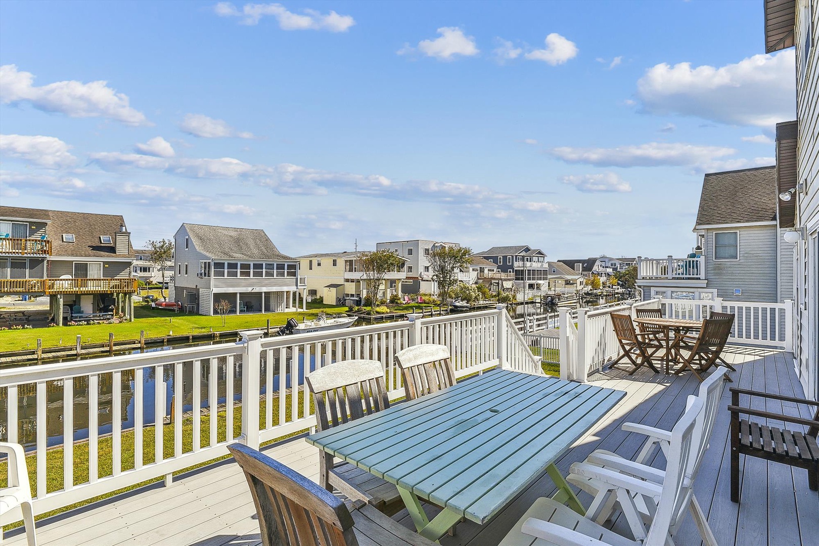 Spacious waterfront deck with peaceful canal views, perfect for morning coffee or sunset dinners overlooking the waterside community.