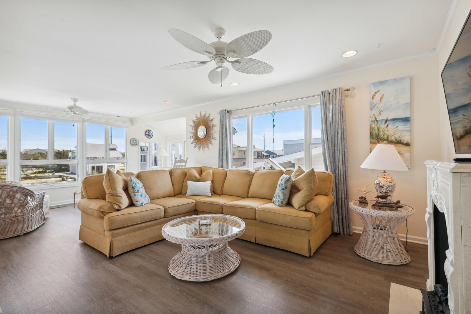 Settle into this sun-filled living room, where soft coastal breezes drift through expansive windows and your beach getaway begins the moment you arrive.