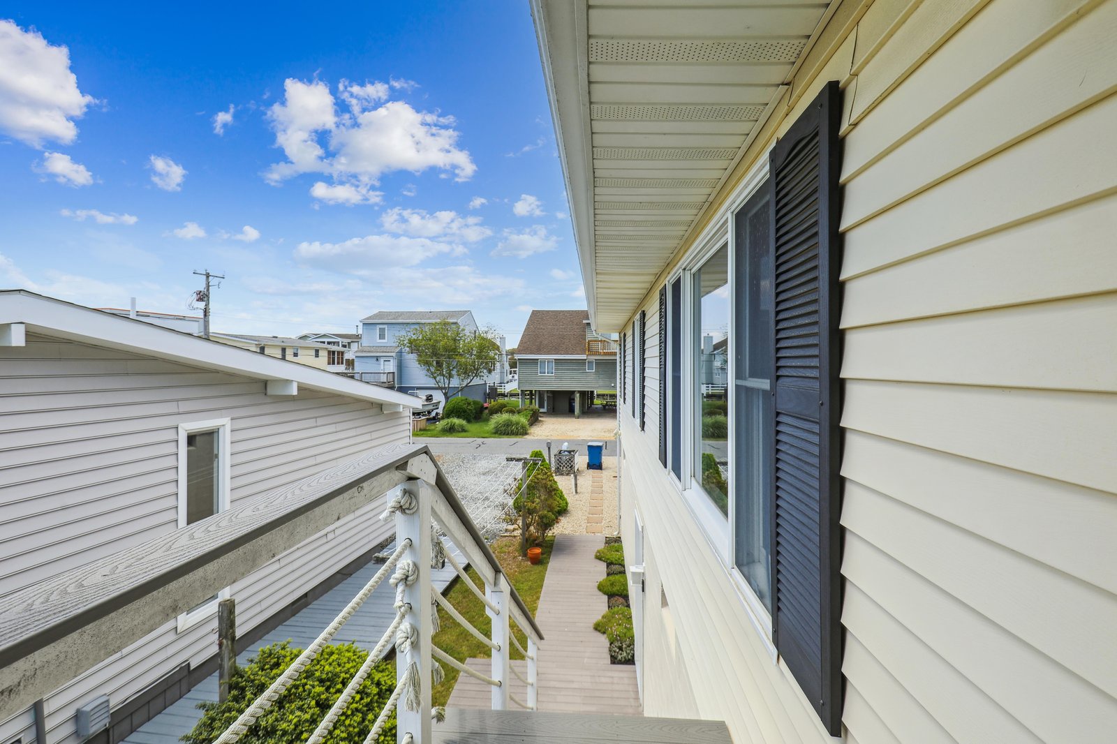 A peaceful residential neighborhood surrounds the property, with nearby homes and a quiet coastal atmosphere perfect for a relaxing beach retreat.