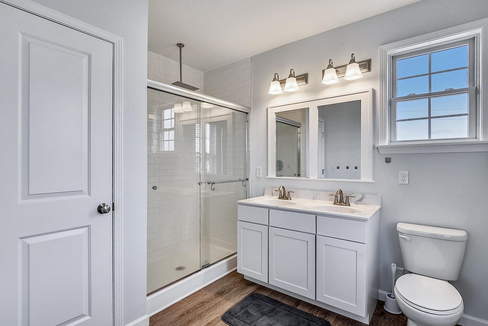 Refresh in your bright, modern bathroom with a walk-in shower and twin sinks—everything you need to start your day comfortably.