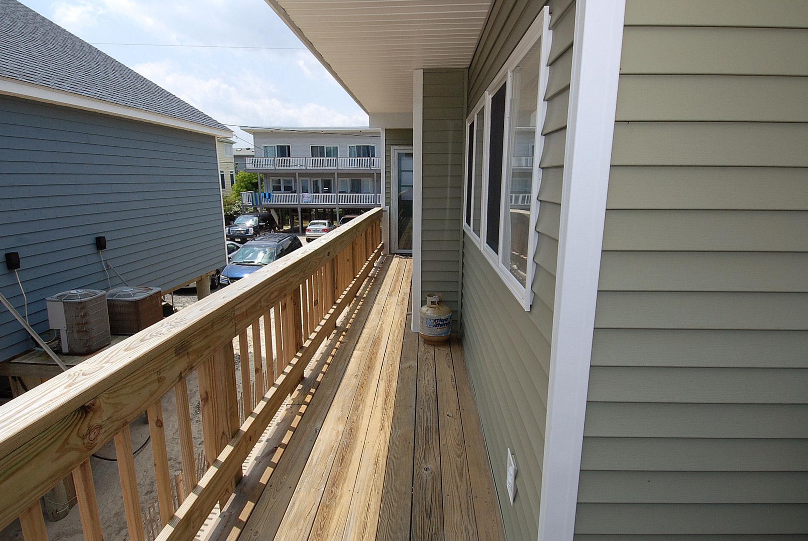 A private wooden deck where you can enjoy your morning coffee or evening breeze, with views of the neighborhood and coastal surroundings.