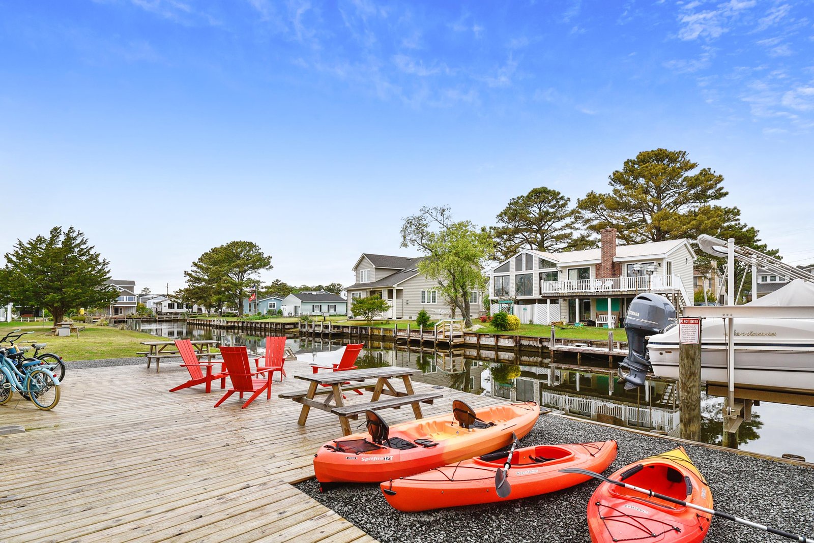 The property sits along a peaceful waterway in a quiet neighborhood, offering kayaks and waterfront access for your adventure.