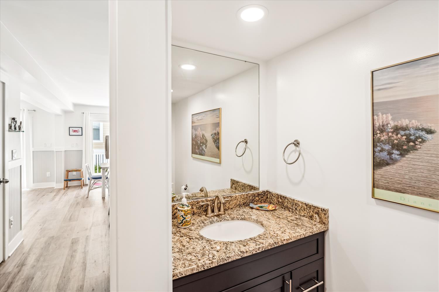 Freshen up at your private vanity with granite countertops and elegant fixtures before exploring your spacious retreat.