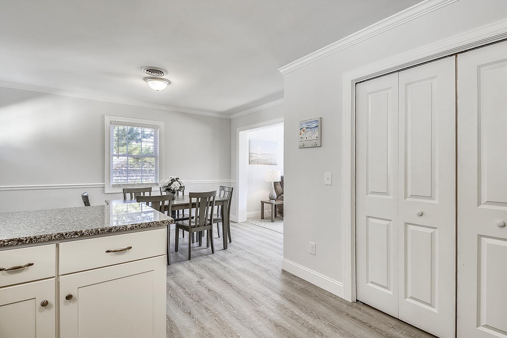 Step into your bright, open kitchen with elegant granite countertops and cozy dining nook—perfect for morning coffee with garden views and easy flow throughout the space.