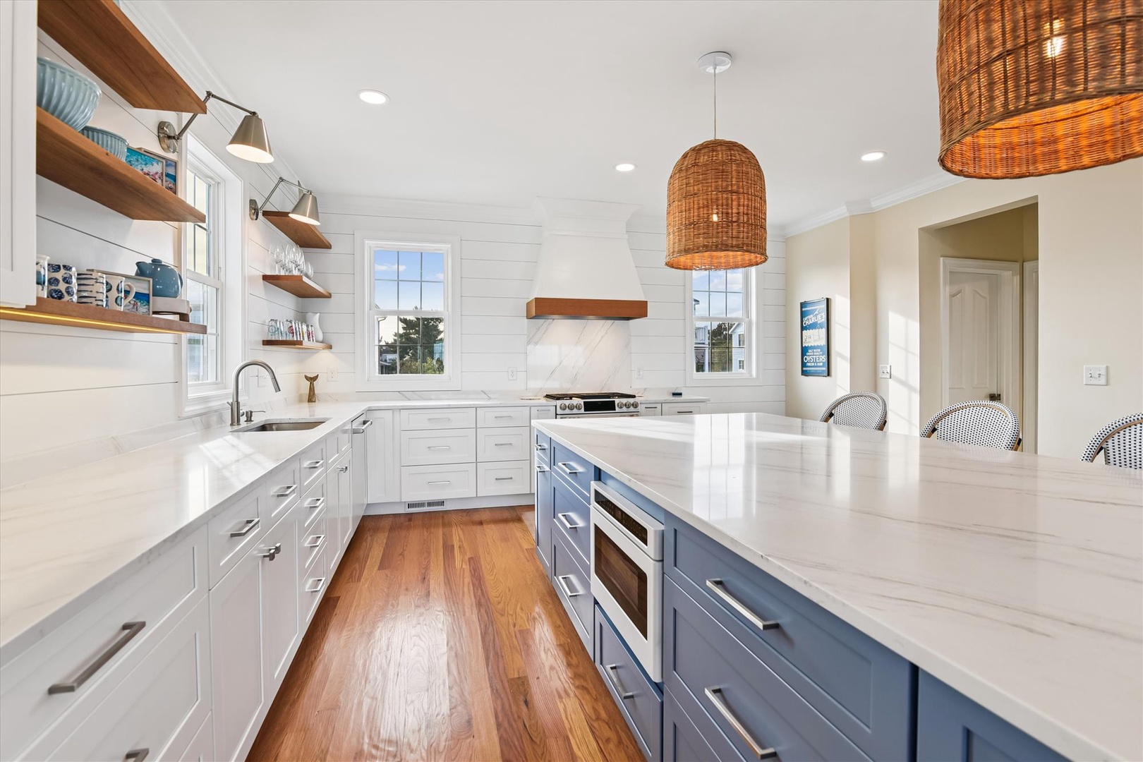 Your dream kitchen awaits—gleaming countertops, custom cabinetry, and coastal-inspired lighting create a bright, airy space where you'll love preparing meals and making memories.