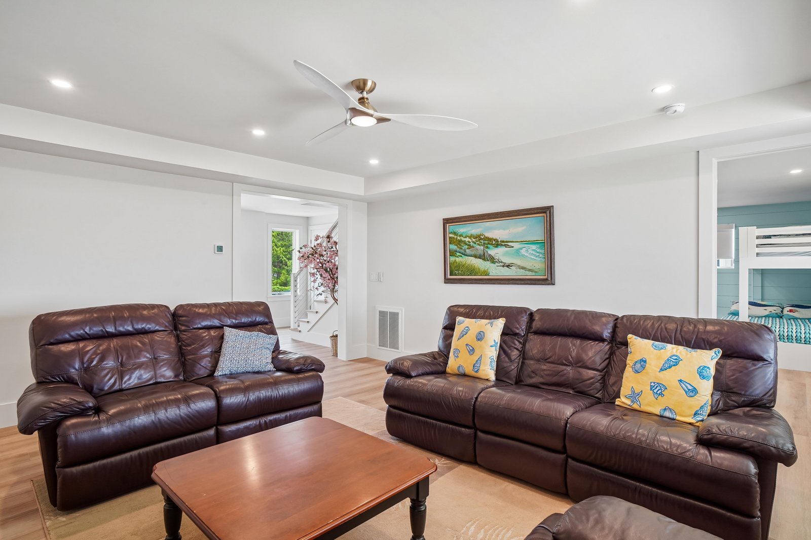 Sink into plush leather seating and let the ceiling fan keep you cool while you relax. Your coastal escape starts here, where comfort meets breezy, laid-back style.