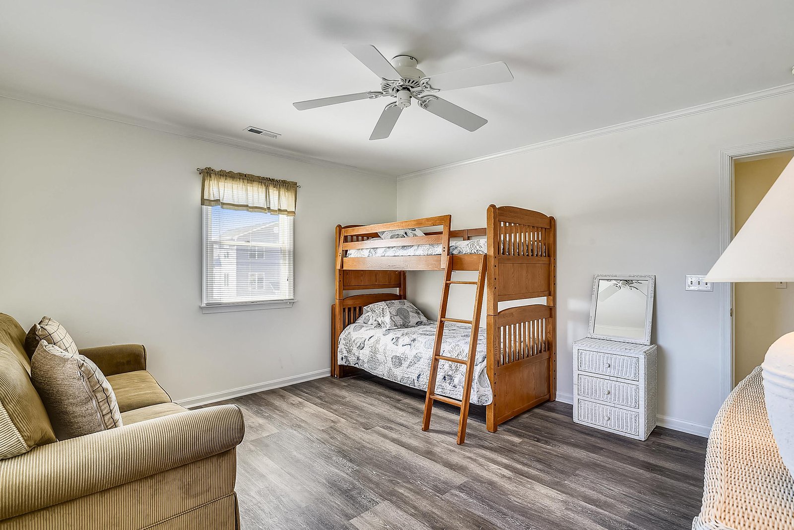 Your spacious bedroom features a cozy bunk bed perfect for kids, plus a comfortable sofa for lounging—everyone has their own spot to relax and unwind.